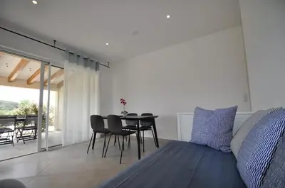 a bedroom with a bed and a table and chairs at Résidence Casa Cintrone in Porto Pollo