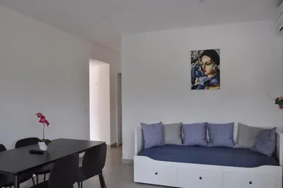 a living room with a bed and a table at Résidence Casa Cintrone in Porto Pollo