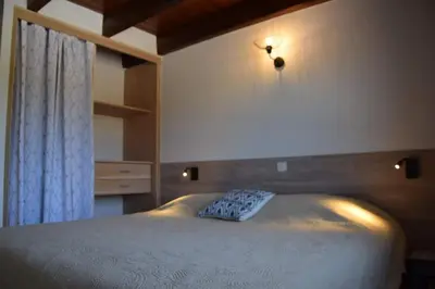 a bedroom with a bed with a light on the wall at Résidence Casa Cintrone in Porto Pollo