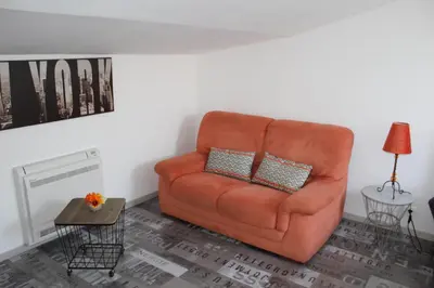 a orange couch sitting in a living room at Claude et Marie-France in Alata