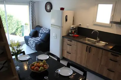 a kitchen with a table with a bowl of fruit on it at Claude et Marie-France in Alata