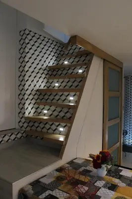 a staircase in a house with wine bottles on it at Claude et Marie-France in Alata