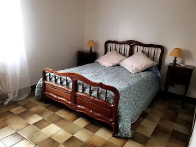 a bedroom with a large wooden bed with two pillows at Beau F4 petreto-Bicchisano in Petreto-Bicchisano