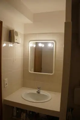 a bathroom with a sink and a mirror at Vue mer Corse in Conca