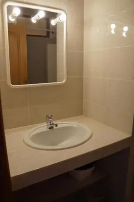a bathroom with a sink with a mirror and a mirror at Vue mer Corse in Conca
