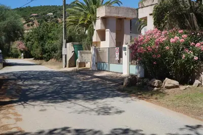 a road with flowers on the side of a building at Vue mer Corse in Conca