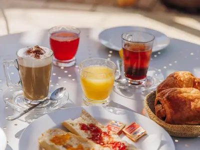 a table topped with plates of food and drinks at Vigna Maggiore in Olmeto
