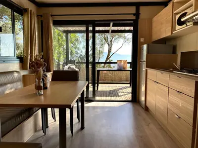 a kitchen with a table and a dining room at Vigna Maggiore in Olmeto