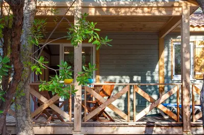 a bowl of fruit on a wooden table on a porch at BAGHEERA Village Naturiste in Linguizzetta