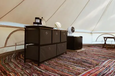 a room with a tent with a dresser and a rug at Village Del Mar in Solaro