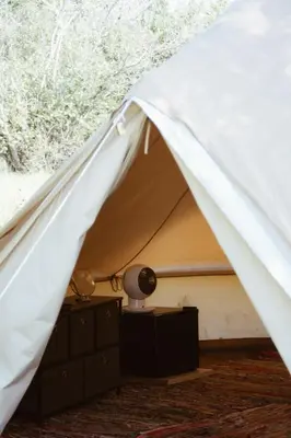 a white tent with a lamp on a dresser at Village Del Mar in Solaro