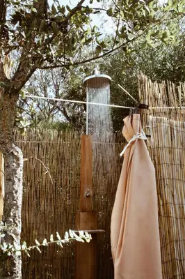 a fence with a water fountain and a robe at Village Del Mar in Solaro