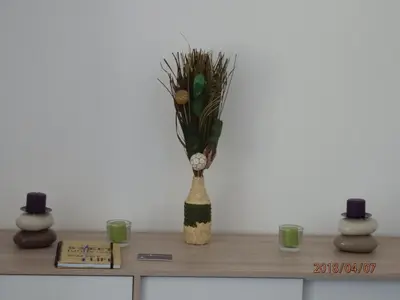 a vase sitting on top of a shelf with two candles at location vacances in Linguizzetta