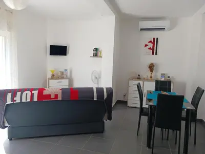 a living room with a couch and a table at location vacances in Linguizzetta
