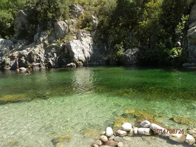 a body of water with rocks in the water at location vacances in Linguizzetta