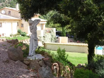 a statue of a woman standing in a yard at Locations Résidence Rocca Rossa Palombaggia classées 3 étoiles in Porto-Vecchio