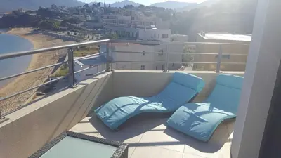two blue chairs sitting on a balcony with a view at Plage Propriano 4 étoiles in Propriano
