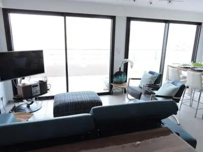 a living room with a couch and chairs and windows at Plage Propriano 4 étoiles in Propriano