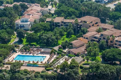 an aerial view of a resort with a swimming pool at Hotel Club Marina Viva in Porticcio