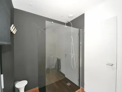 a shower with a glass door in a bathroom at Sunset Villa with Bay View in Molini
