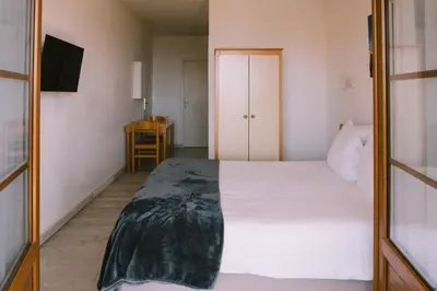 a bedroom with a white bed and a mirror at Creste E Mare in Ajaccio