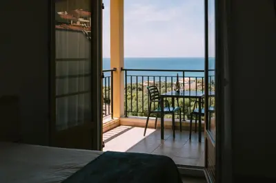 a bedroom with a view of the ocean from a balcony at Creste E Mare in Ajaccio