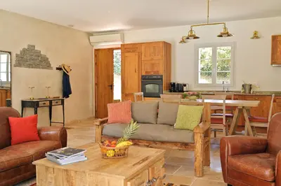 a living room with a couch and a table at Domaine de Bracciole in Corte