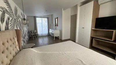a bedroom with a bed and a television in a room at Villa Altea- Lido Marana - piscine privée exclusive - plage à pied - 3 bedrooms house - private swimming pool - beach access on foot in Bastia