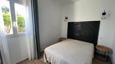 a small bedroom with a bed and a window at Villa Altea- Lido Marana - piscine privée exclusive - plage à pied - 3 bedrooms house - private swimming pool - beach access on foot in Bastia