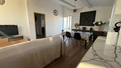 a living room with a couch and a table with chairs at Villa Altea- Lido Marana - piscine privée exclusive - plage à pied - 3 bedrooms house - private swimming pool - beach access on foot in Bastia