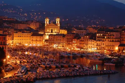 a group of boats in a harbor at night at Villa Altea- Lido Marana - piscine privée exclusive - plage à pied - 3 bedrooms house - private swimming pool - beach access on foot in Bastia