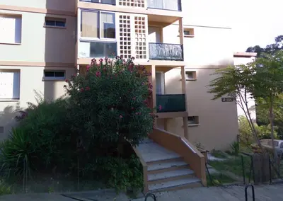 a building with a staircase in front of a building at Appartement Lumineux Vue Panoramique in Ajaccio