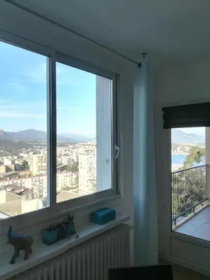 a window in a room with a view of a city at Appartement Lumineux Vue Panoramique in Ajaccio