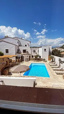a swimming pool in the middle of a house at Hôtel Restaurant La Caravelle in Sari Solenzara