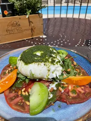 a plate of food with beans and vegetables on a table at Hôtel Restaurant La Caravelle in Sari Solenzara