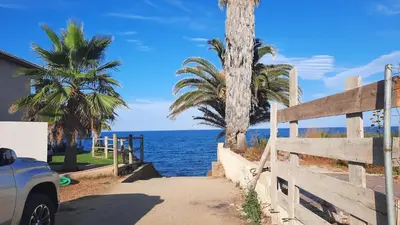 a car parked on a road next to the ocean at Résidence Sognu Di Mare - Plage in Linguizzetta