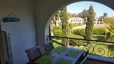 a dining room with a table and a large window at Résidence Sognu Di Mare - Plage in Linguizzetta