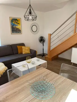a living room with a couch and a table at Duplex en plein centre in Propriano