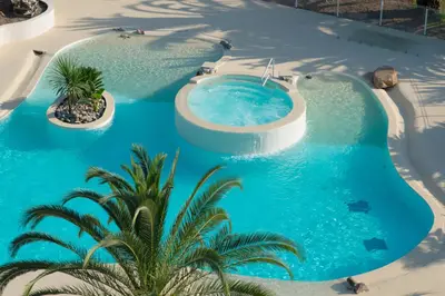 an overhead view of a swimming pool with blue water at Hôtel Campo Dell'oro in Ajaccio