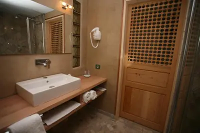 a bathroom with a white sink and a mirror at Hôtel Campo Dell'oro in Ajaccio