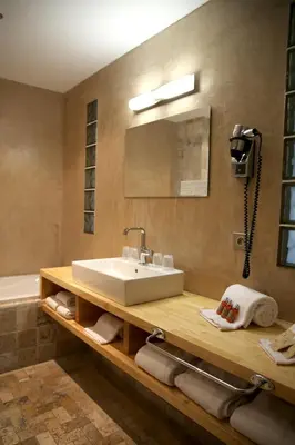 a bathroom with a sink and a mirror and a tub at Hôtel Campo Dell'oro in Ajaccio