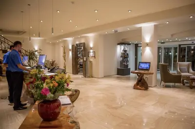 a man standing at a counter in a store at Hôtel Campo Dell'oro in Ajaccio