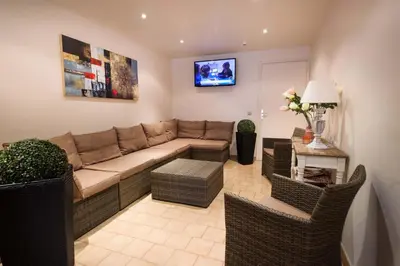 a living room with a couch and chairs at Hotel et Résidence Cala di sole in Porto Ota