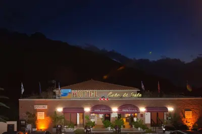 a hotel building with a sign on it at night at Hotel et Résidence Cala di sole in Porto Ota