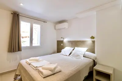 a bedroom with a bed with two towels on it at Résidence Stella di Mare in Sainte-Lucie de Porto-Vecchio