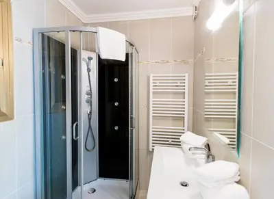 a bathroom with a shower and a toilet and a sink at Résidence Stella di Mare in Sainte-Lucie de Porto-Vecchio