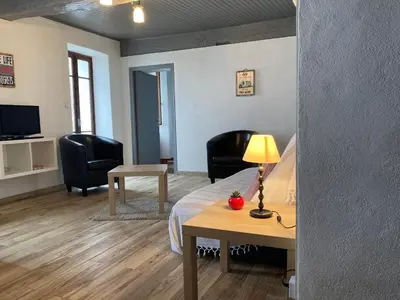 a room with a bed and two chairs and a table at Casa a Stretta in Castello-di-Rostino