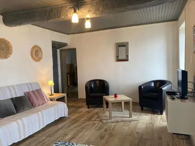 a living room with a couch and chairs and a tv at Casa a Stretta in Castello-di-Rostino