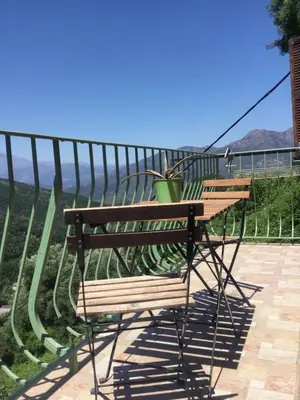 a wooden bench with a potted plant sitting on it at Casa a Stretta in Castello-di-Rostino