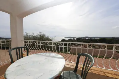 a table and chairs on a balcony with a view at Residence Monte Cristo in Sainte-Lucie de Porto-Vecchio
